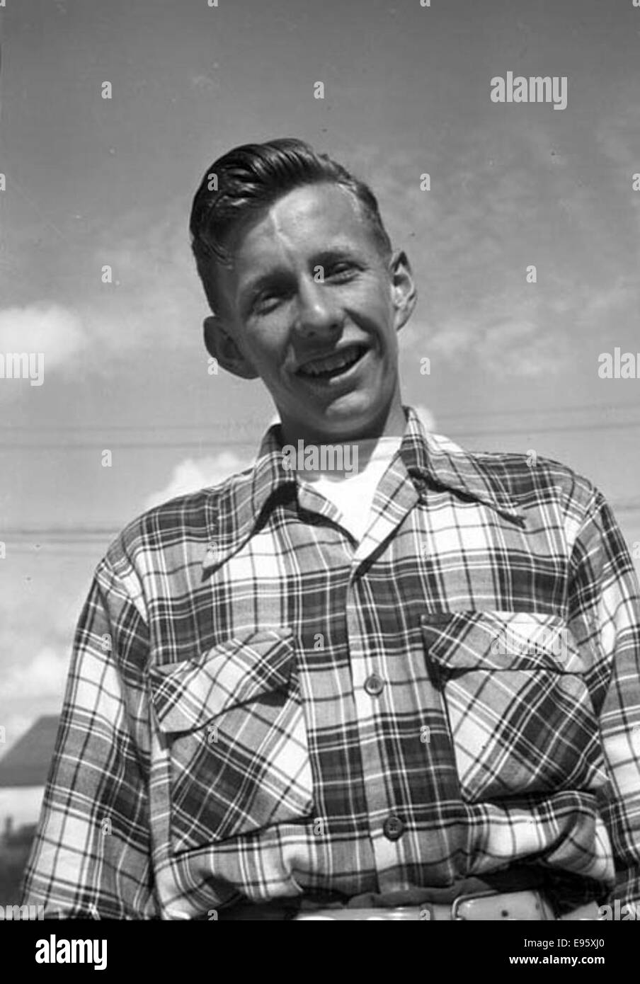 A young man smiles at the camera outdoors. 13 June 1948 21/4 x 31/4 negative This is one of 54 photos in the album “Fort Macleod’s Anonymous”. Most are shot in Fort Macleod, Alberta in the late 1940s. The donor o Stock Photo