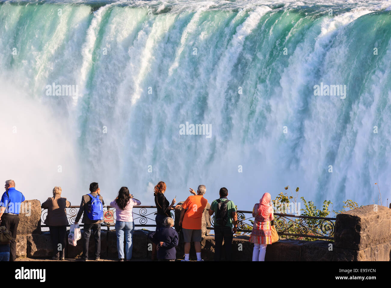 Tourists overlooking and enjoying the view at the Horseshoe Falls, part of the Niagara Falls, Ontario, Canada. Stock Photo