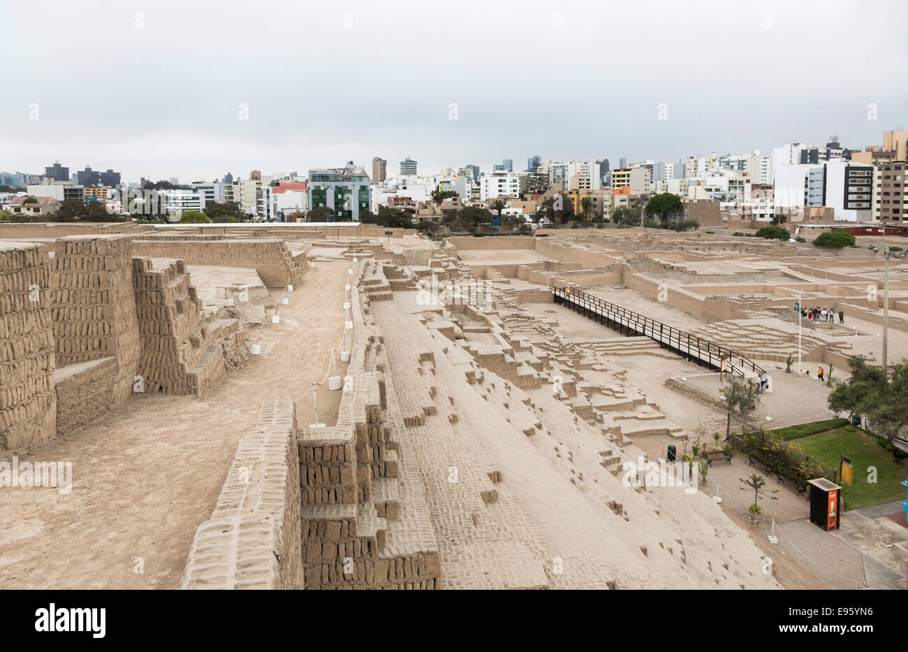 Sightseeing ancient Peruvian culture / heritage: view of Huaca Pucllana or Huaca Juliana pyramid, with modern Miraflores, Lima, Peru in the background Stock Photo
