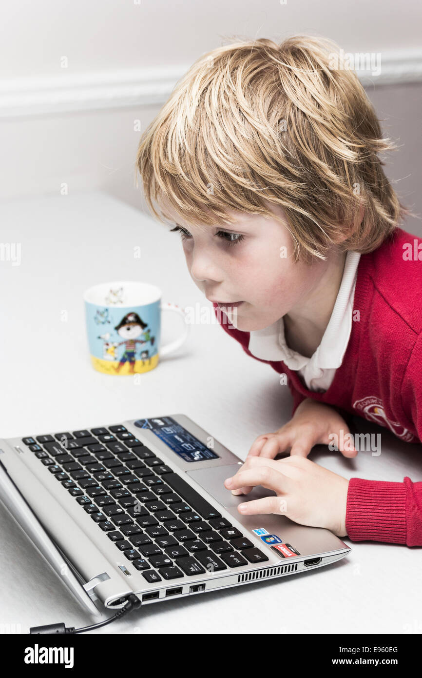 Young boy concentrating on computer screen Stock Photo