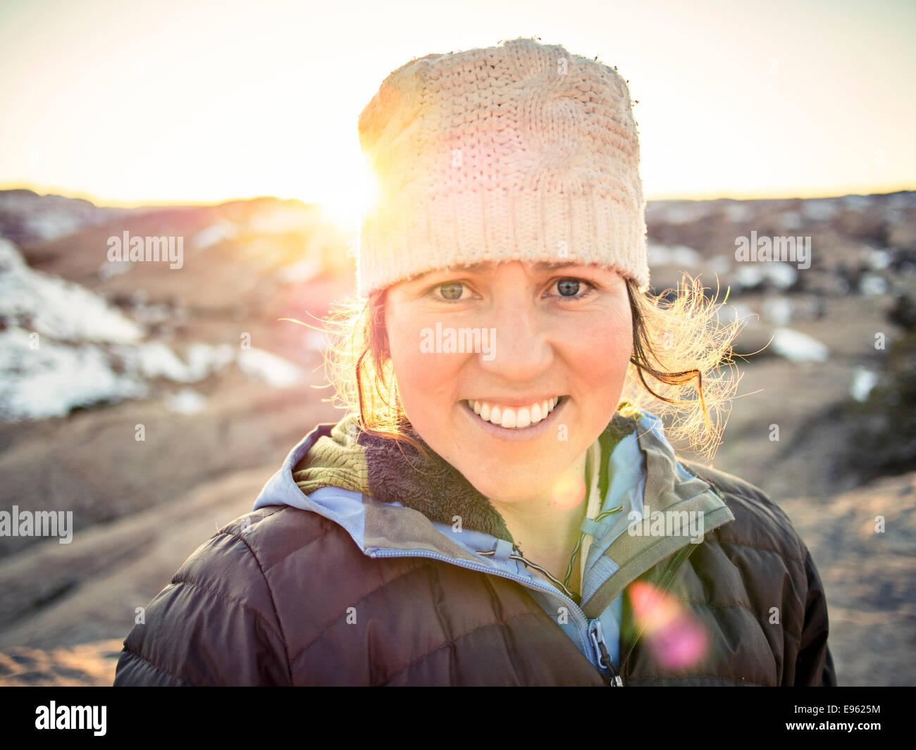 Claire Appel, woman looking at camera with sun behind her. Moab, Utah. Stock Photo