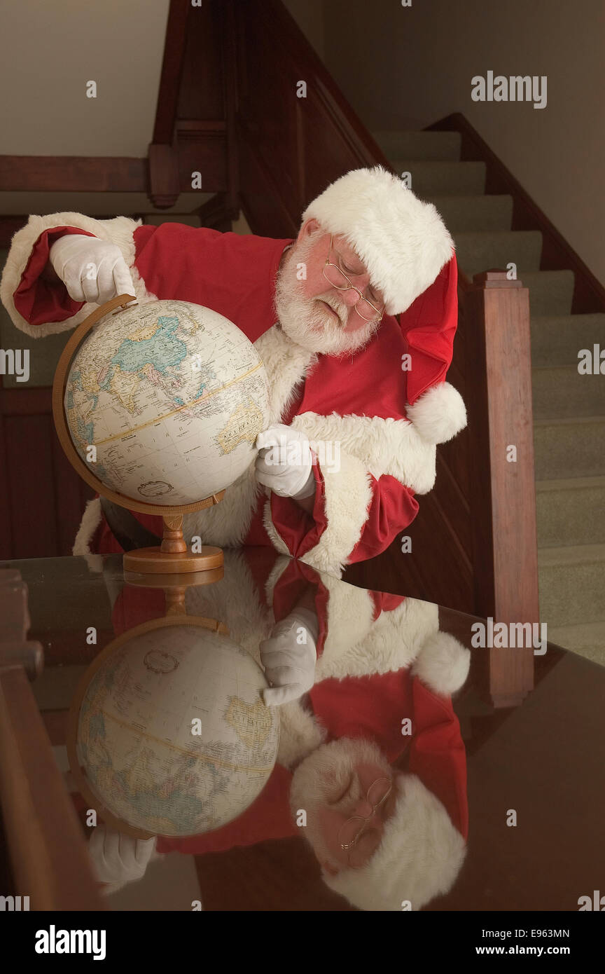 Santa planning his trip from the North Pole Stock Photo