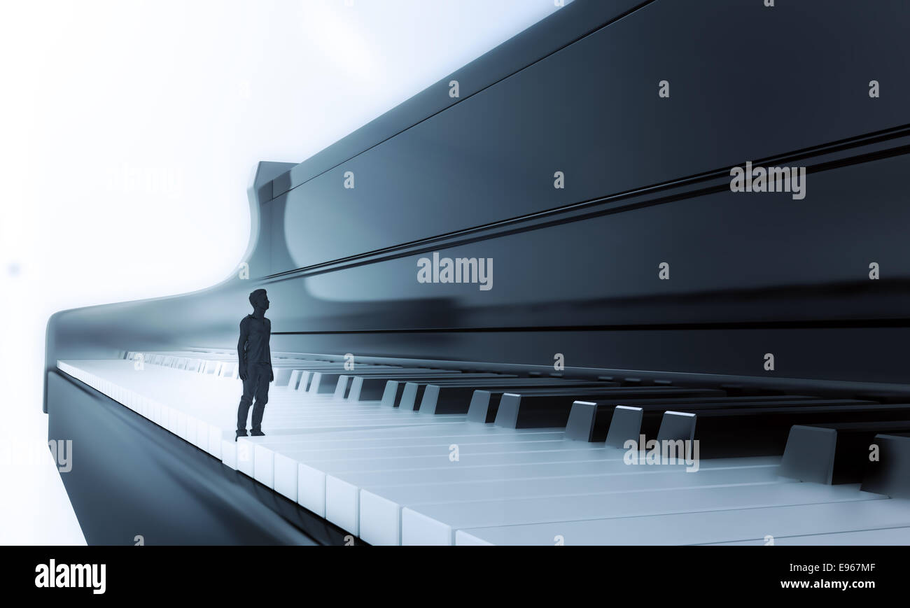 Tiny man standing on a classical piano keyboard Stock Photo