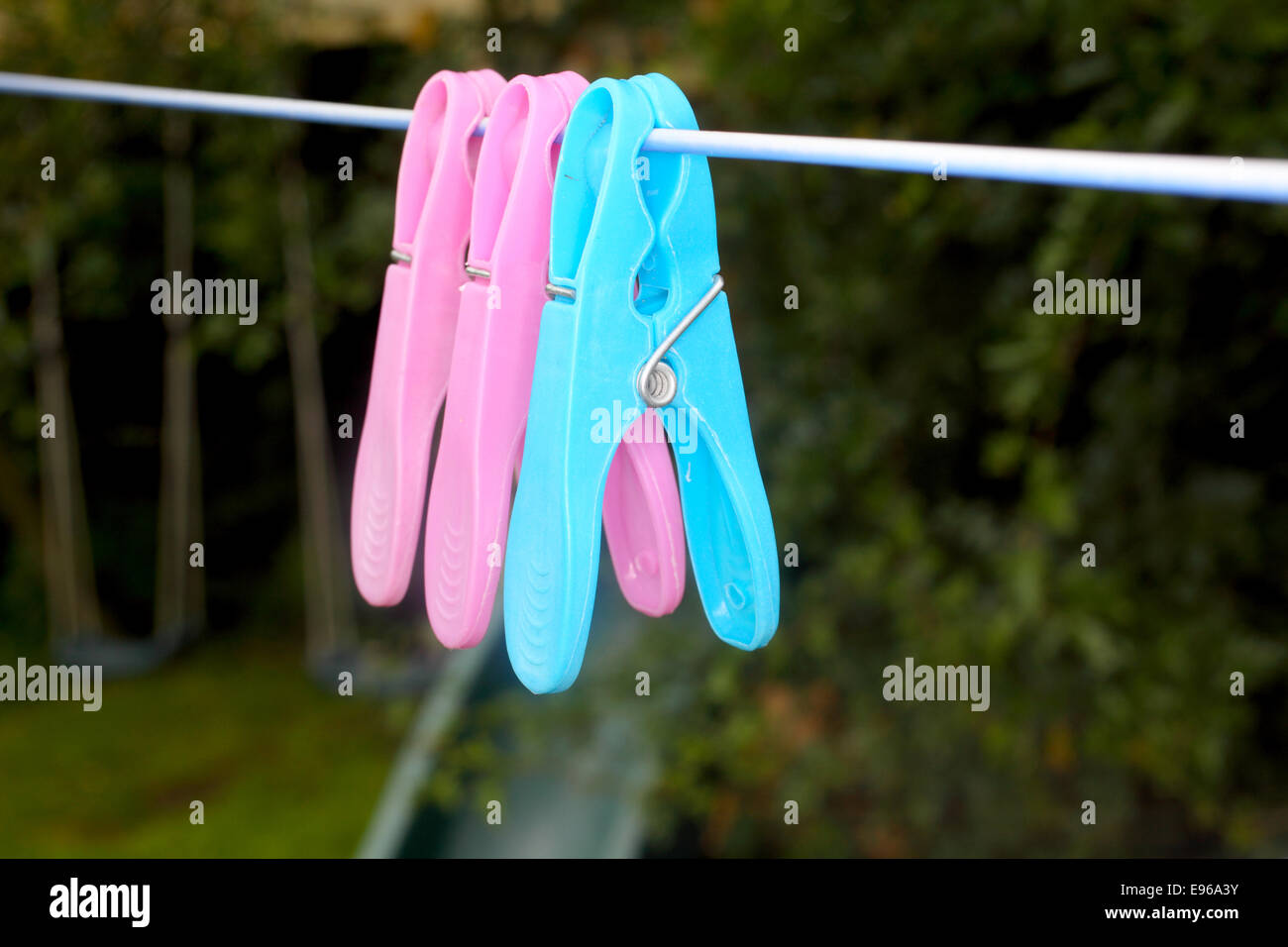 Colorful Clothes Pin Hanging on Rope Stock Photo