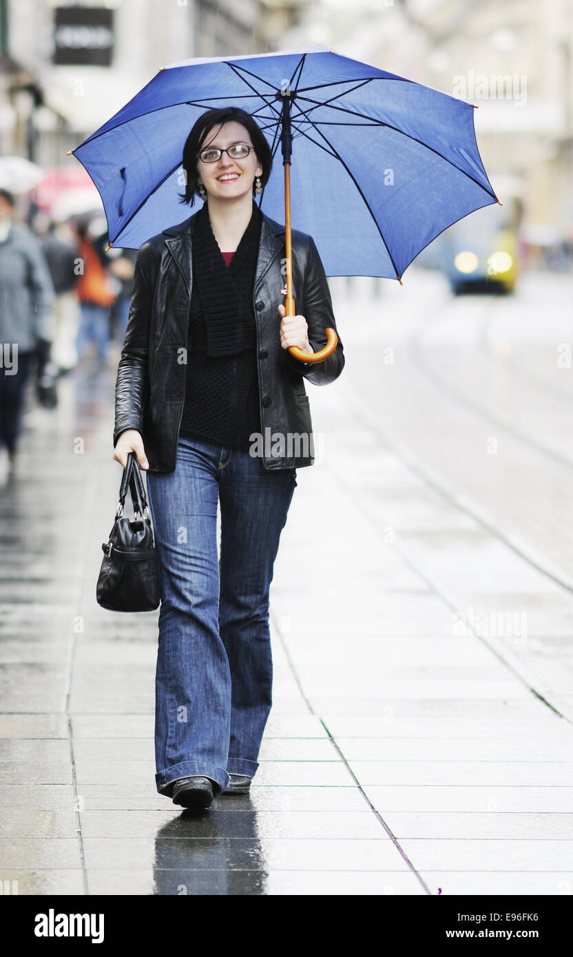 woman on street with umbrella Stock Photo - Alamy