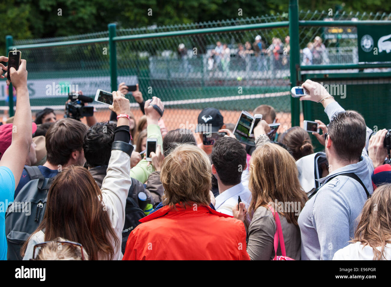 Rafa Nadal,cap, surrounded by fans after he practiced on outside court,Roland Garros,French Open tennis tournament,Paris,France Stock Photo