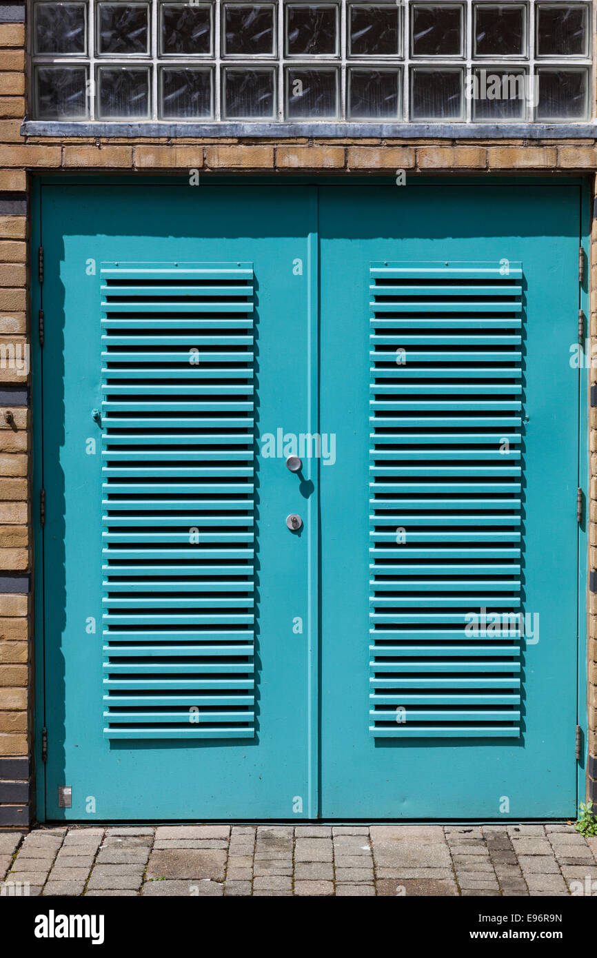 Louvered blue metal outside doors Stock Photo Alamy