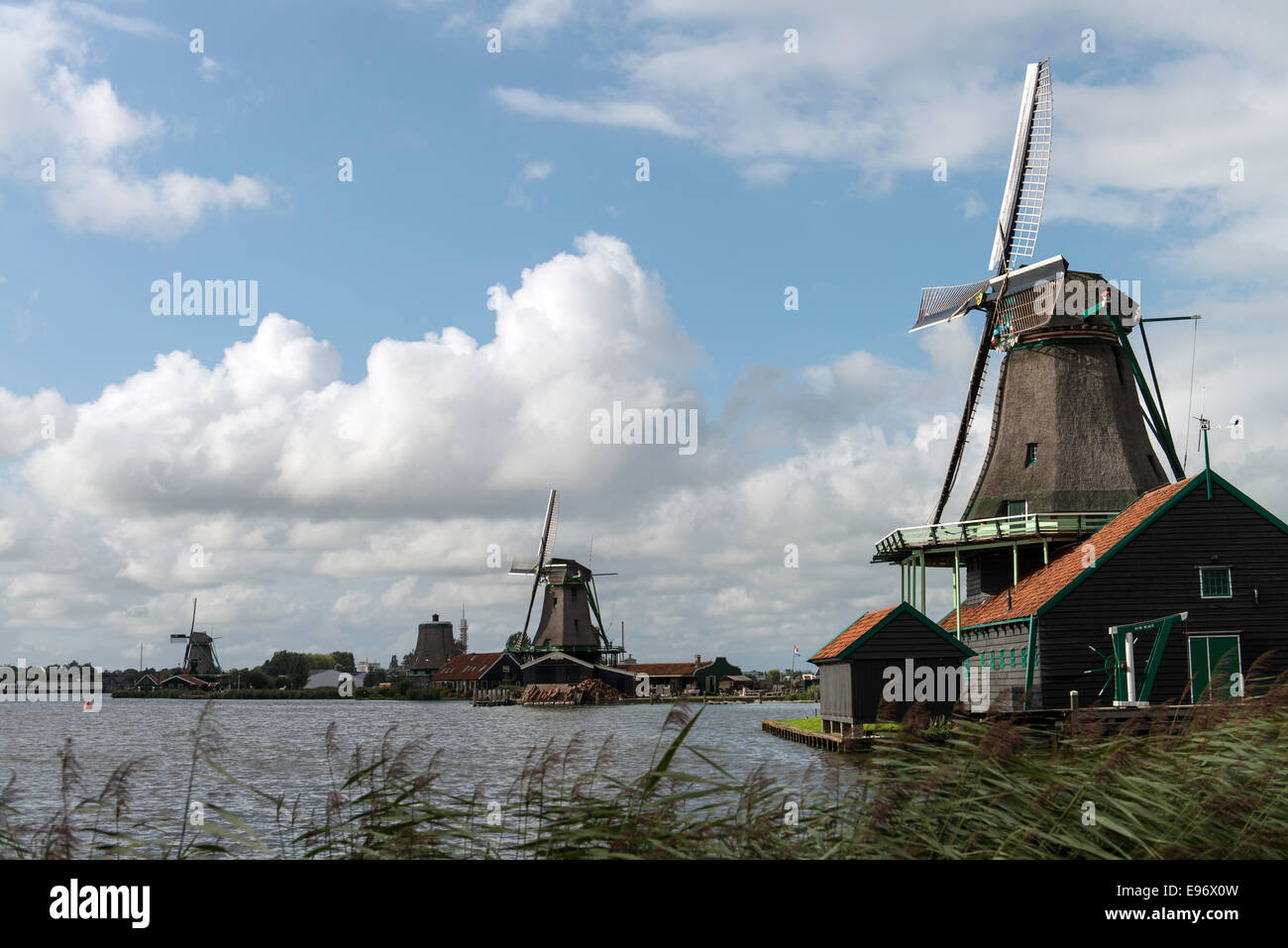 Traditional Dutch windmills with canal in Zaanse Schans near Amsterdam, Holland, Netherlands, Europe Stock Photo