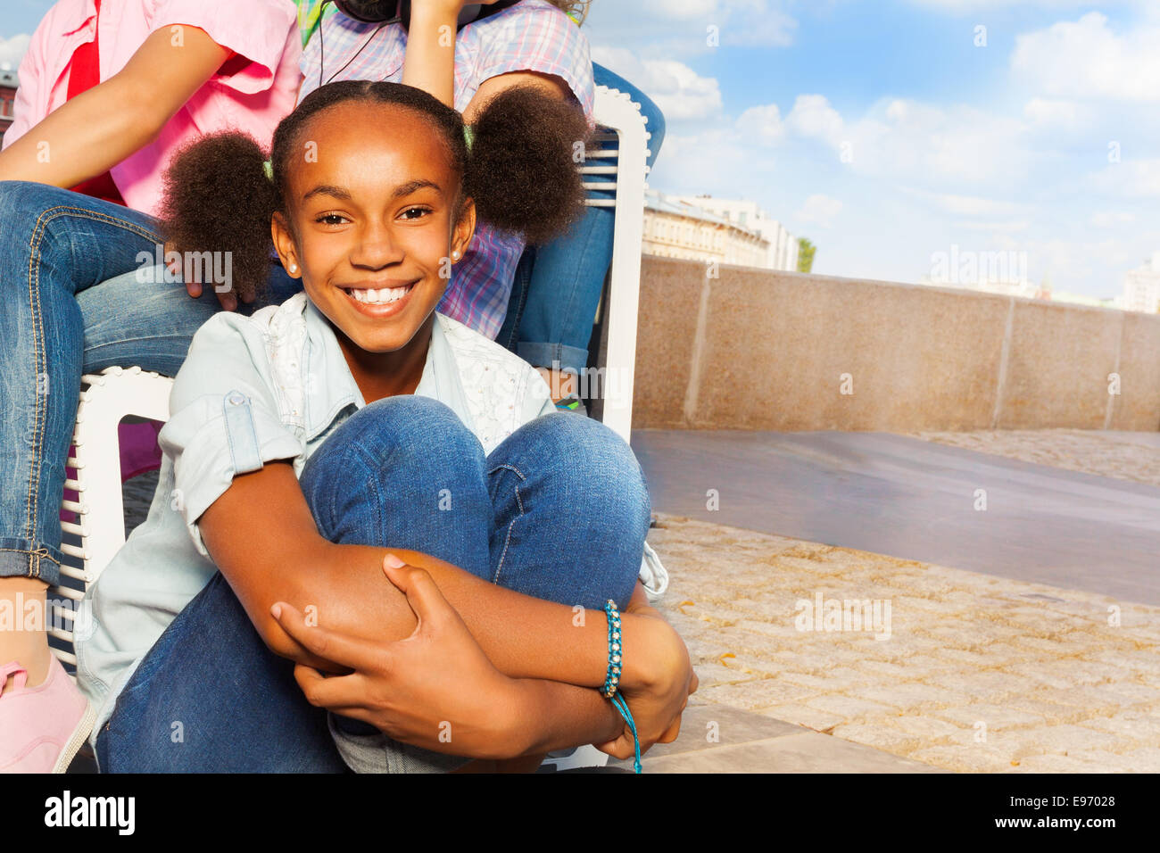 Teen girl sitting knees up hi-res stock photography and images - Alamy