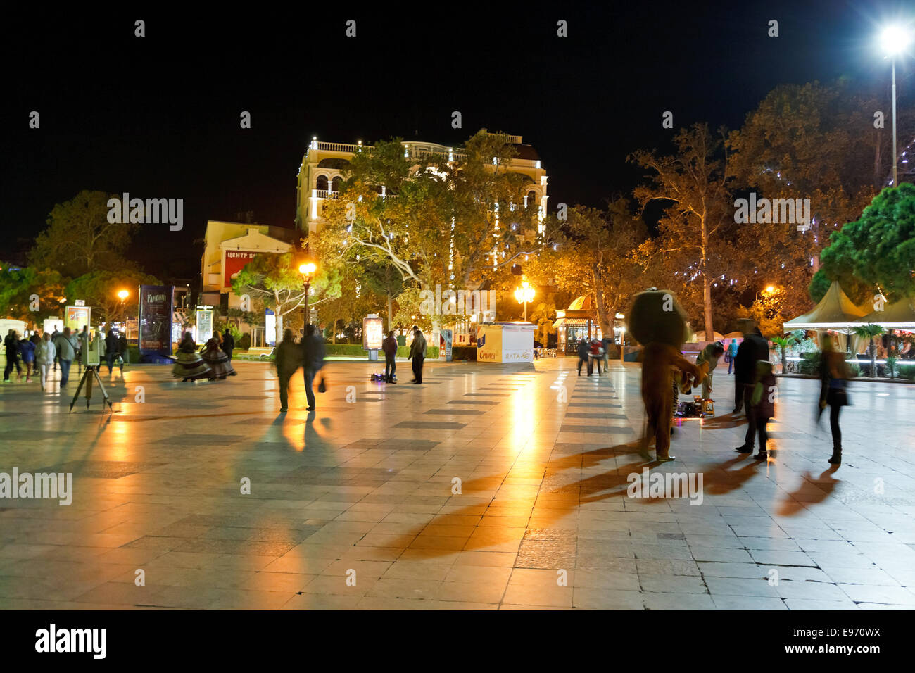 YALTA, RUSSIA - OCTOBER 2, 2014: tourists walking on promenade in Yalta city in night. Yalta is resort city on the north coast o Stock Photo