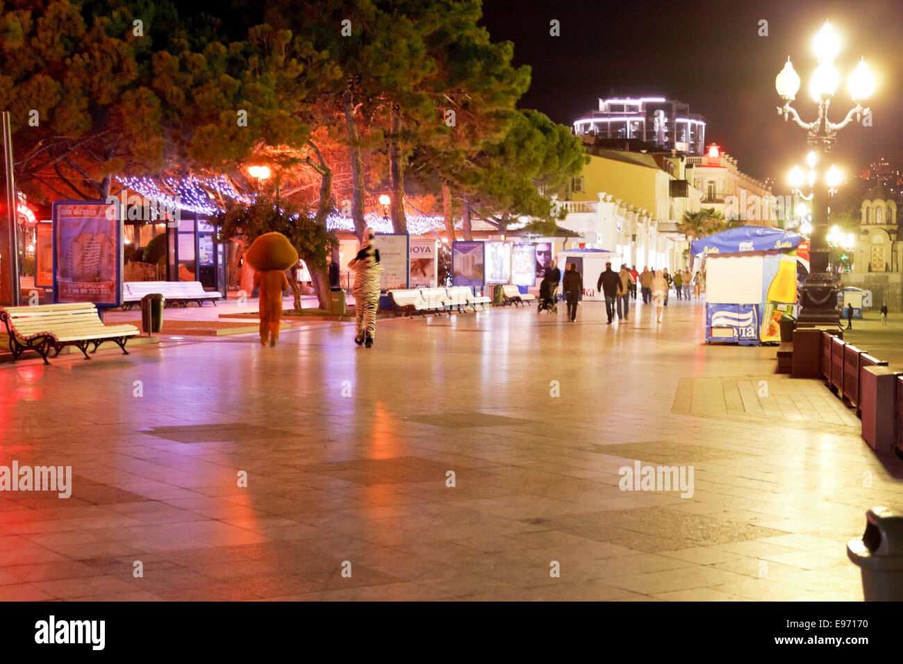 YALTA, RUSSIA - OCTOBER 2, 2014: people walking on quay in Yalta city in night. Yalta is resort city on the north coast of the B Stock Photo
