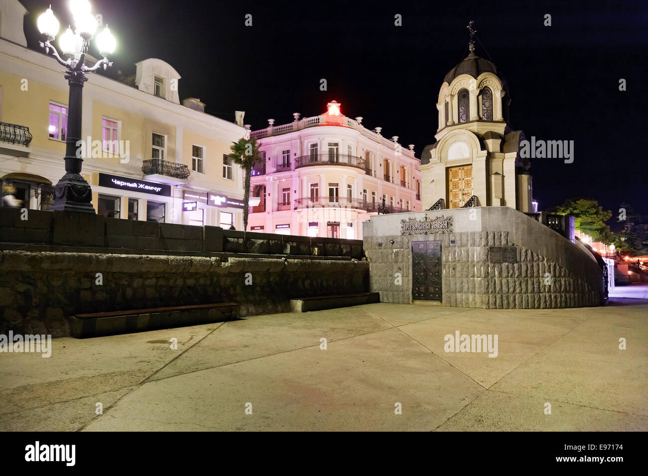 YALTA, RUSSIA - OCTOBER 2, 2014: chapel on quay in Yalta city in night. Yalta is resort city on the north coast of the Black Sea Stock Photo