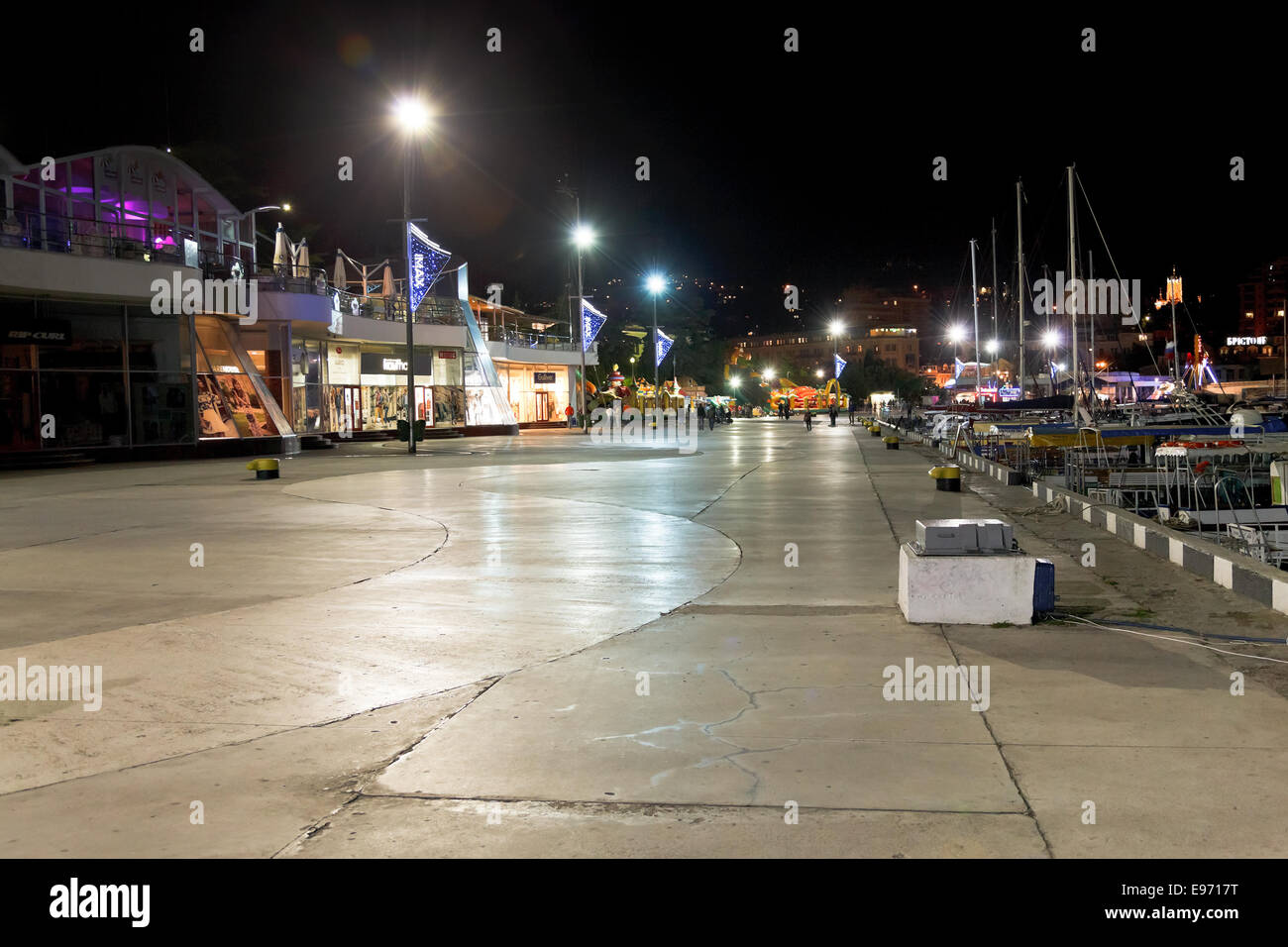YALTA, RUSSIA - OCTOBER 2, 2014: people walking on seafront in Yalta city in night. Yalta is resort city on the north coast of t Stock Photo