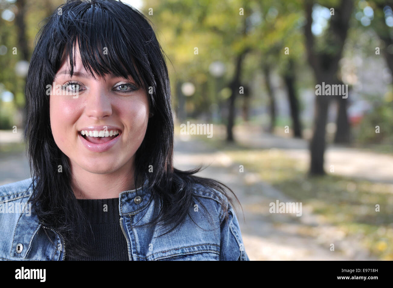 Happy young woman smiling Stock Photo - Alamy