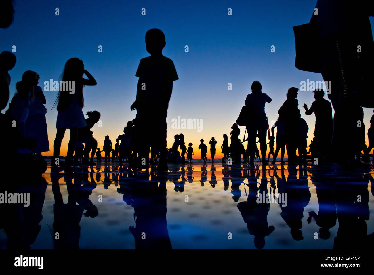People reflections on colorful sunset Stock Photo