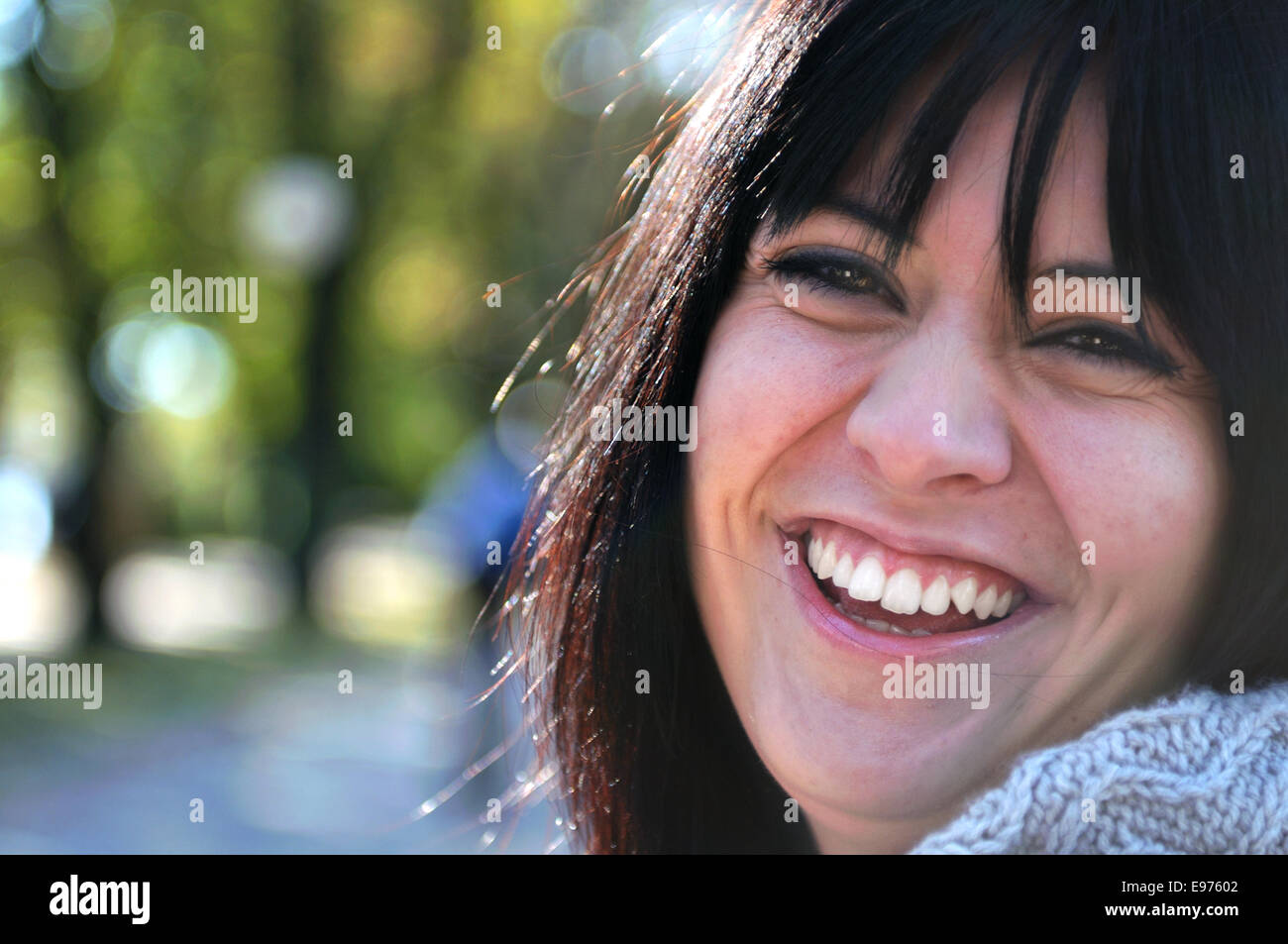 brunette Cute young woman smiling outdoors Stock Photo - Alamy