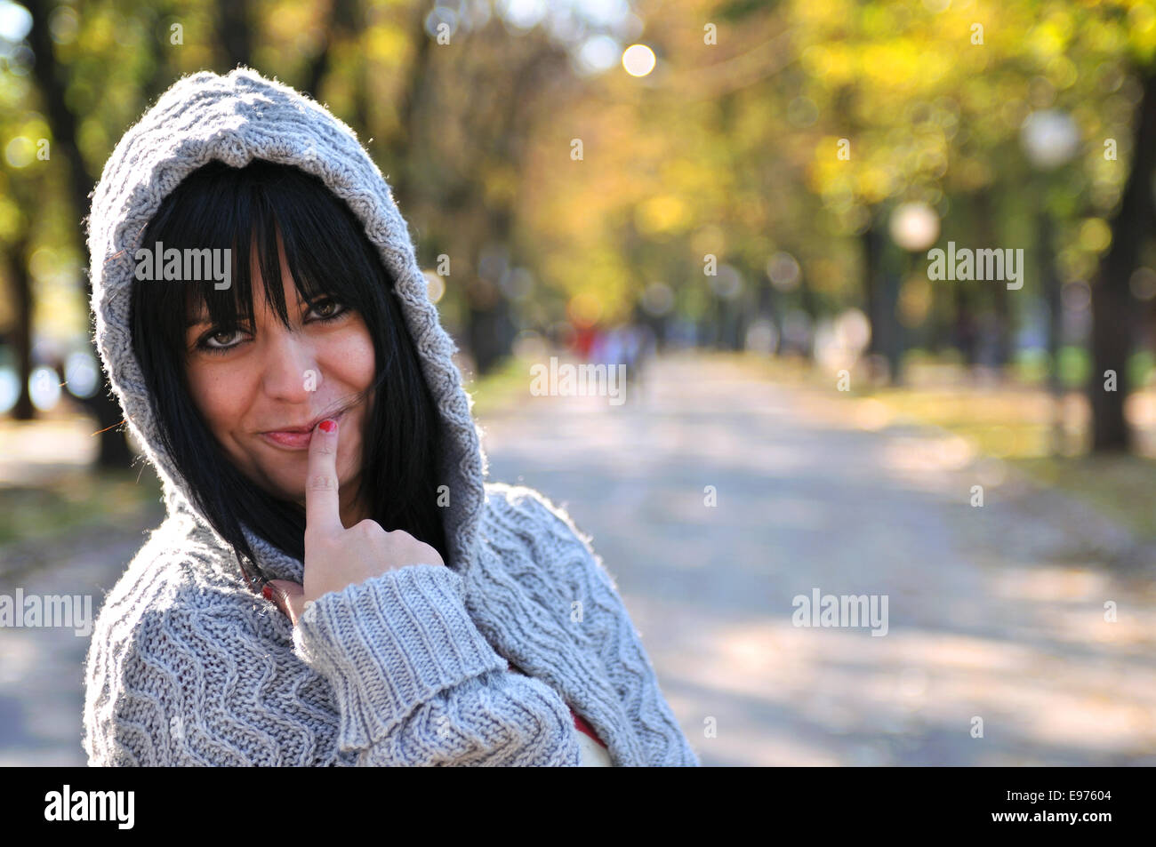 brunette Cute young woman smiling outdoors Stock Photo - Alamy