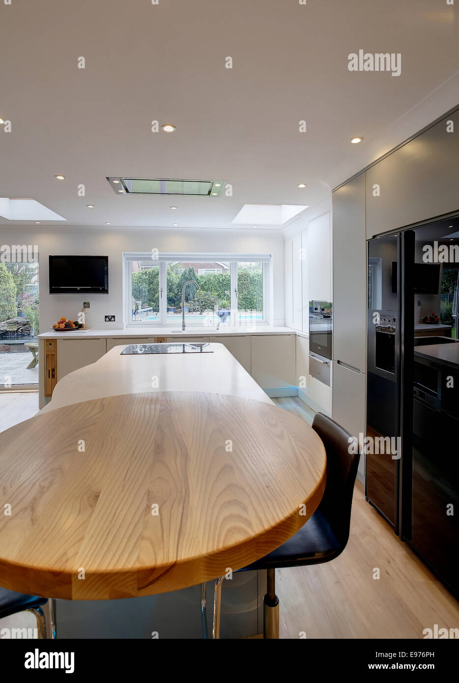 A Modern Kitchen Inside A Home In The Uk With A Round Wooden Breakfast Island Stock Photo Alamy