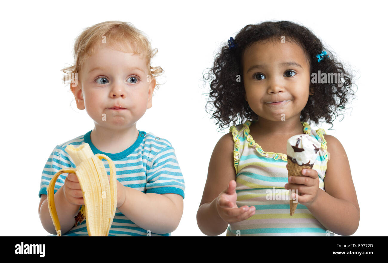 Two kids boy and girl eading fruit and ice cream isolated Stock Photo