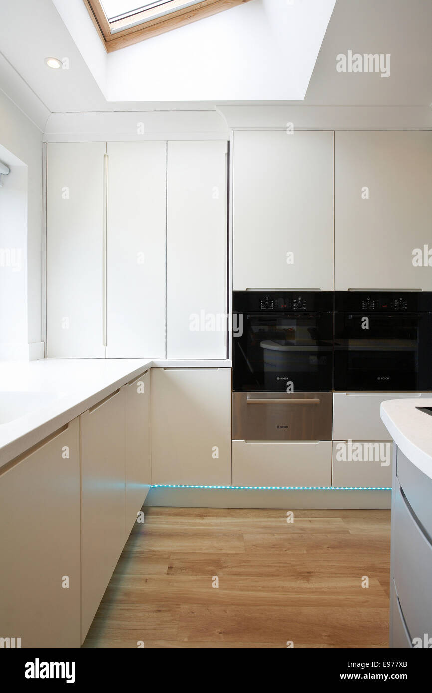 A Modern White Kitchen Inside A Home In The Uk With Folding