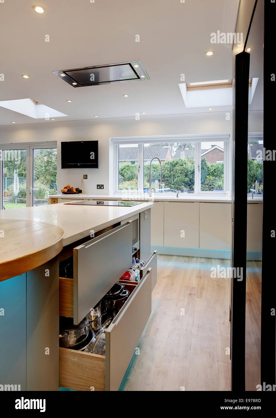 A Kitchen in a home in the UK with a few sliding drawers partially open