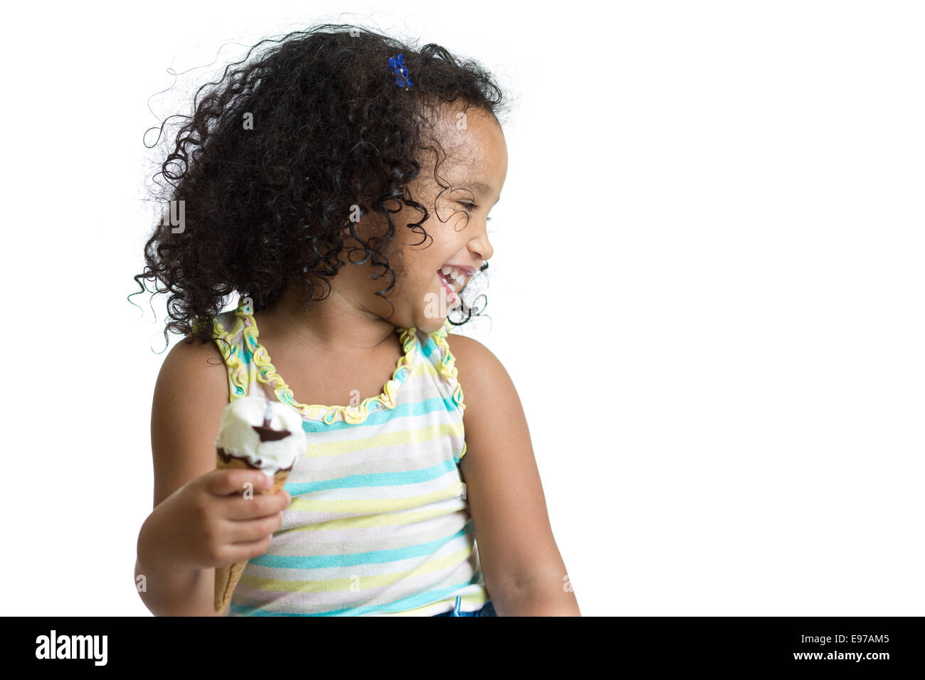 Kid eating ice cream looking aside isolated Stock Photo