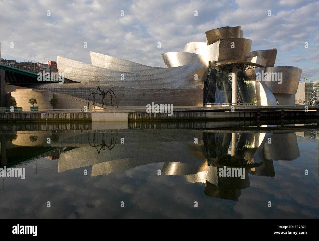 The Guggenheim Museum in Bilbao Spain reflecting in the river Nervion Stock Photo