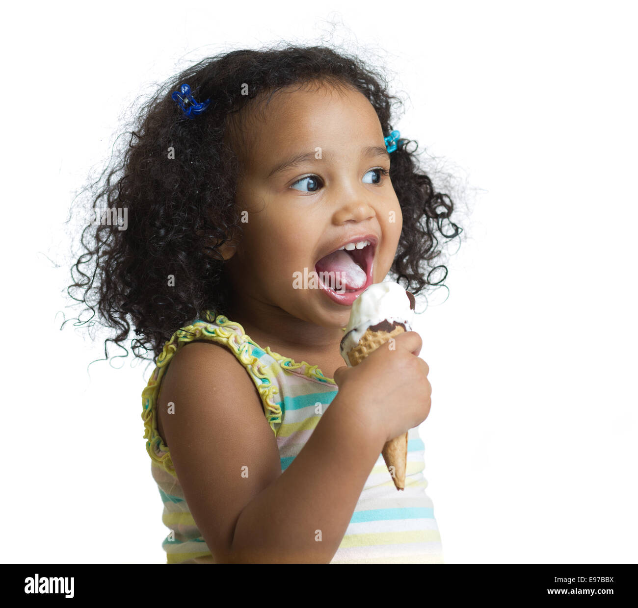 Kid eating ice cream isolated and looking aside Stock Photo