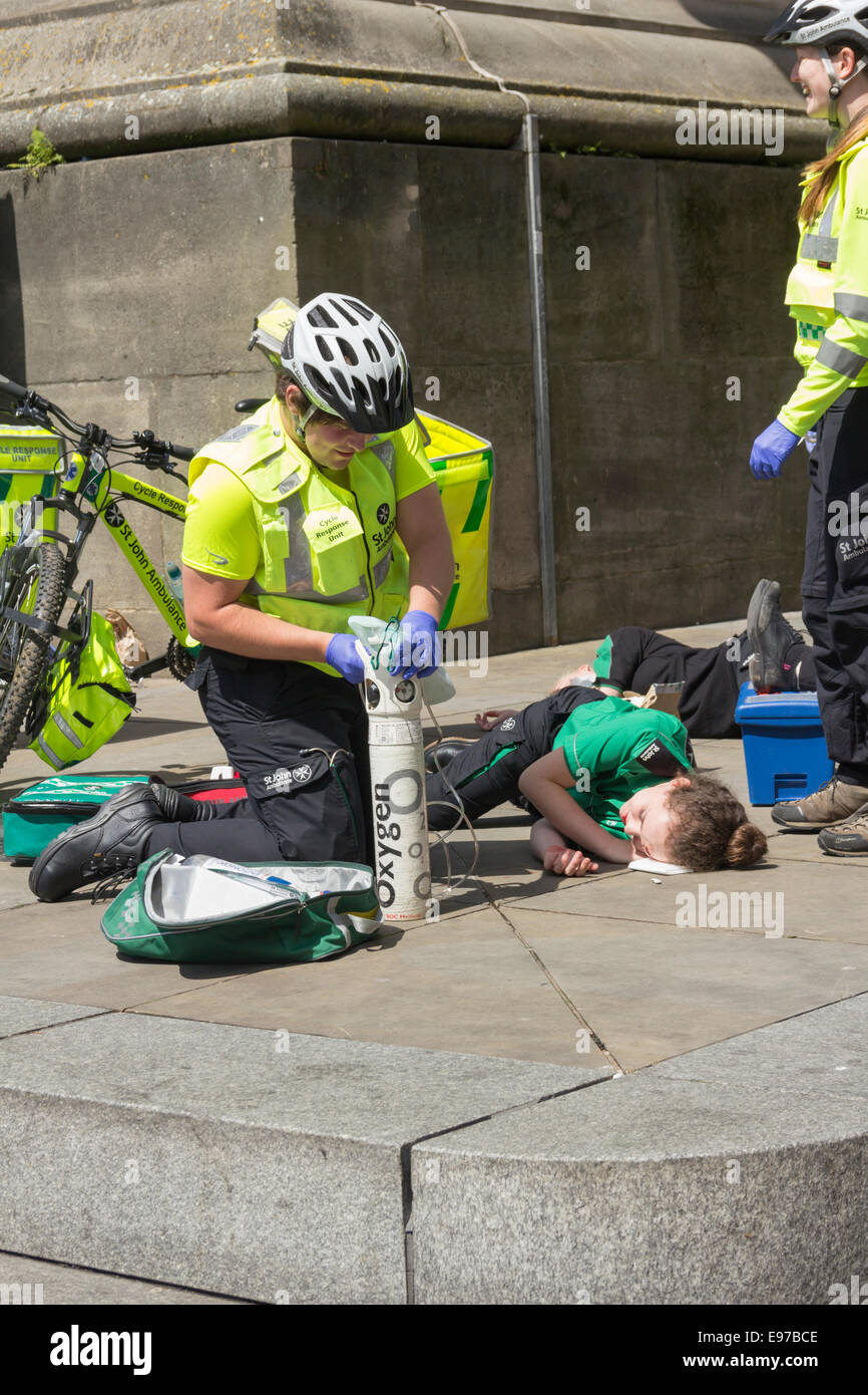 St. John Ambulance volunteers demonstrating oxygen administration on a woman with a simulated injury in Newcastle. Stock Photo