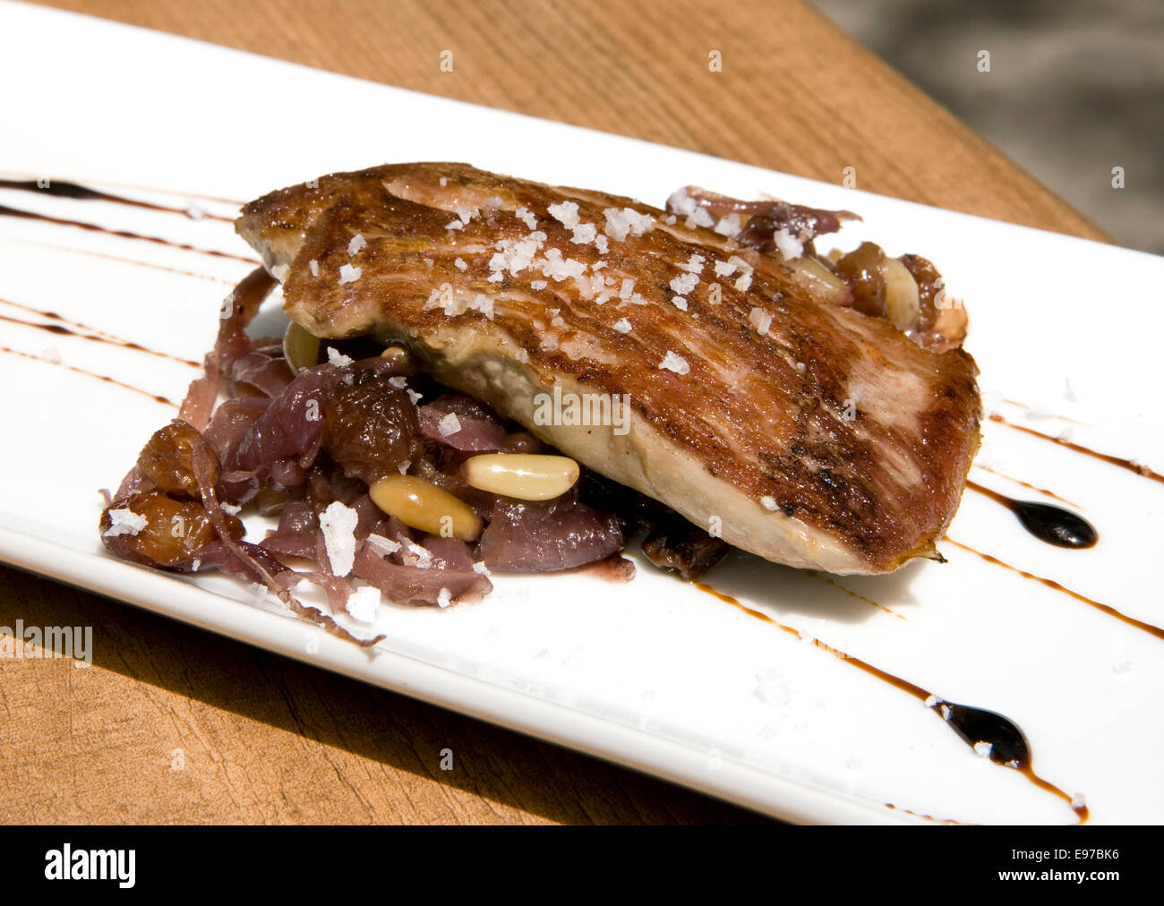 Tapas, pork fillet with red onion and pine nuts Stock Photo