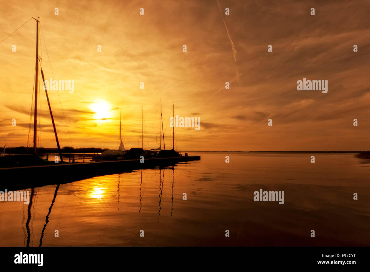 Sunset at Lake Steinhude, marina and moored sail boats Stock Photo