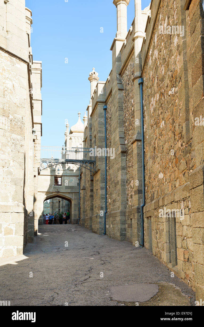 ALUPKA, RUSSIA - SEPTEMBER 28, 2014: tourists in Shuvalov Passage of Vorontsov Palace in Crimea. The palace was built in 1828-18 Stock Photo