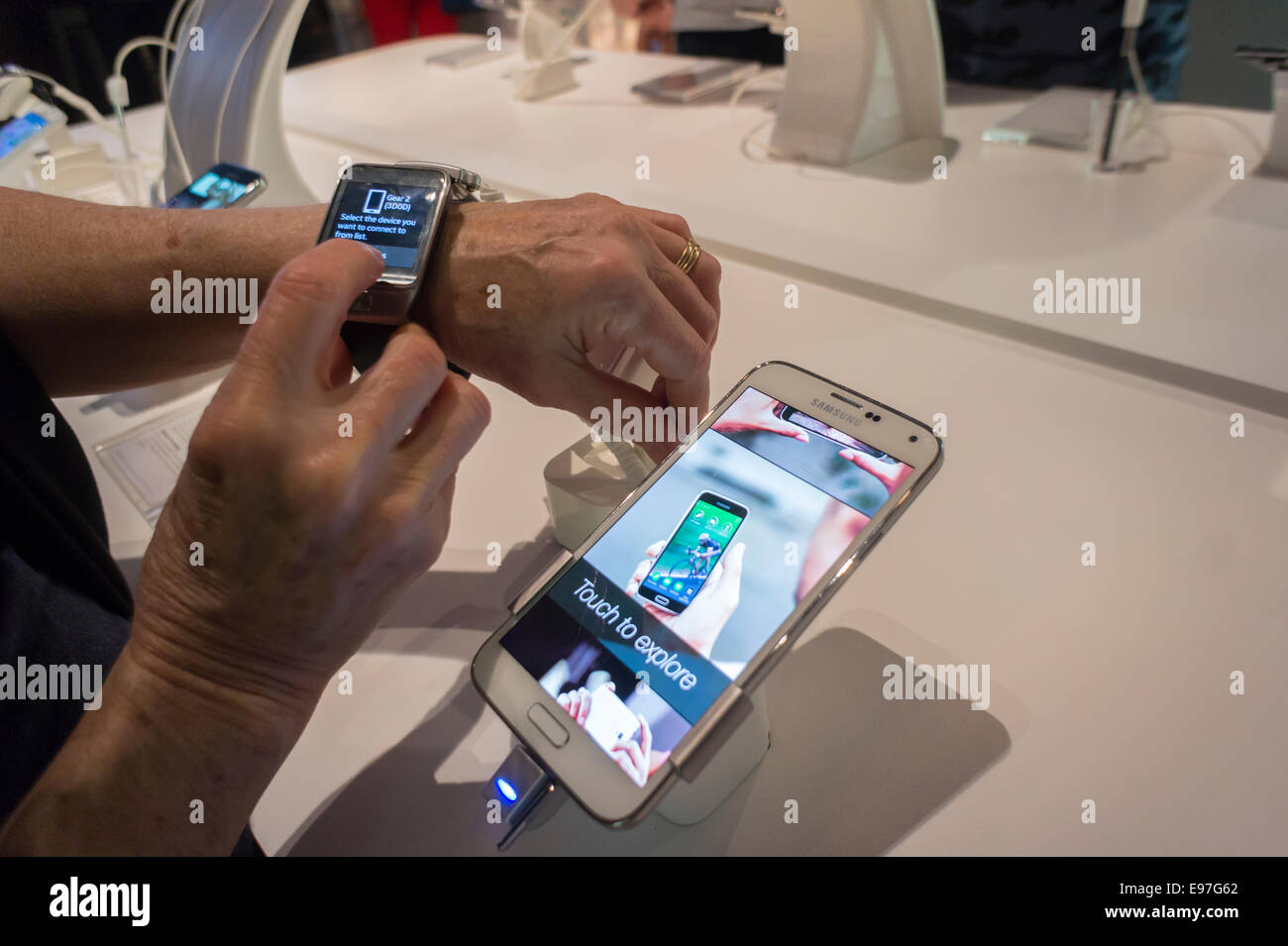 A visitor tries out Samsung products, including their smart watches, in a Samsung  pop-up shop in Soho in New York Stock Photo - Alamy