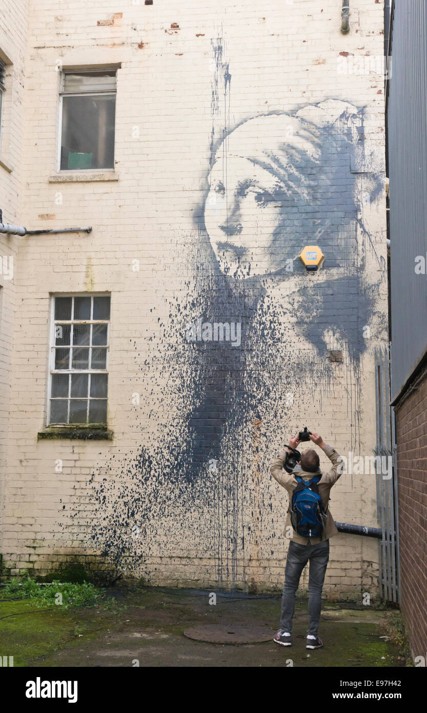 Bristol, UK. 21st Oct, 2014. The latest Banksy mural Girl with the Pierced Eardrum appeared recently, it is a parody of Vermeer's Girl with a Pearl Earring, the jewelry being replaced with a burglar alarm. Sometime in the last 24 hours it has been vandalised by splashing paint over it. Credit:  Mr Standfast/Alamy Live News Stock Photo