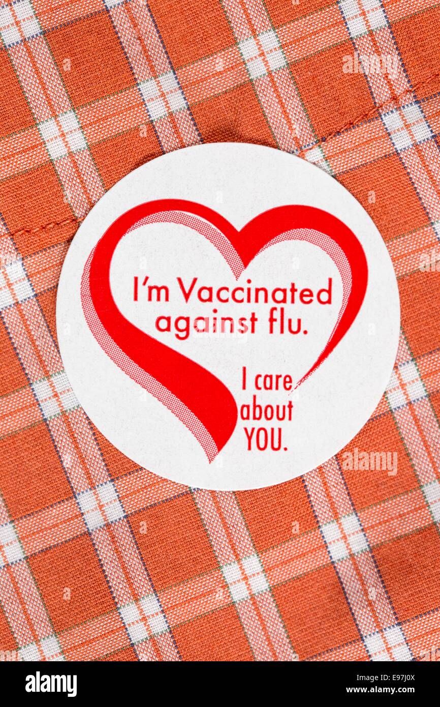 I’m Vaccinated against flu sticker badge on an orange plaid shirt Stock Photo