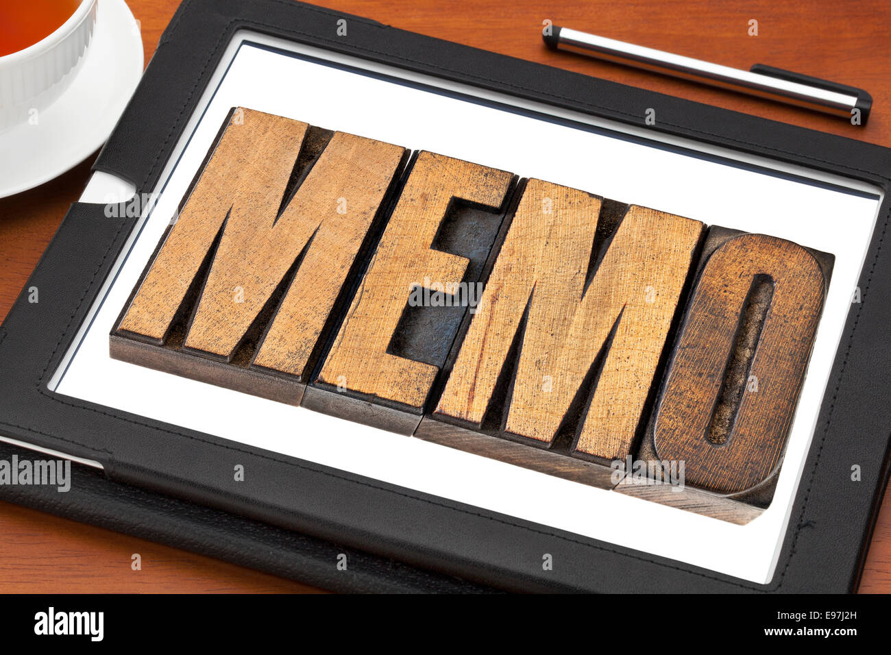 memo word in letterpress wood type on a digital tablet with tea Stock Photo