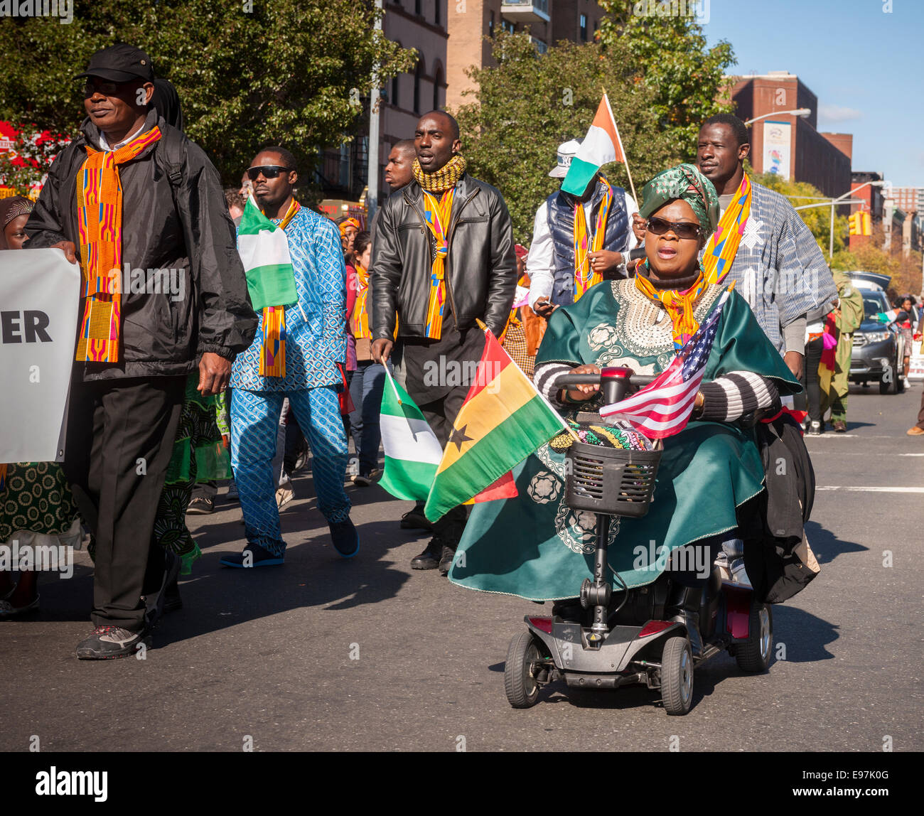 Participants carry flags from many African nations marching in the