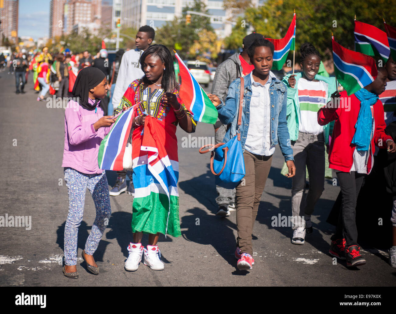 Participants carry flags from many African nations marching in the African Day Parade in Harlem