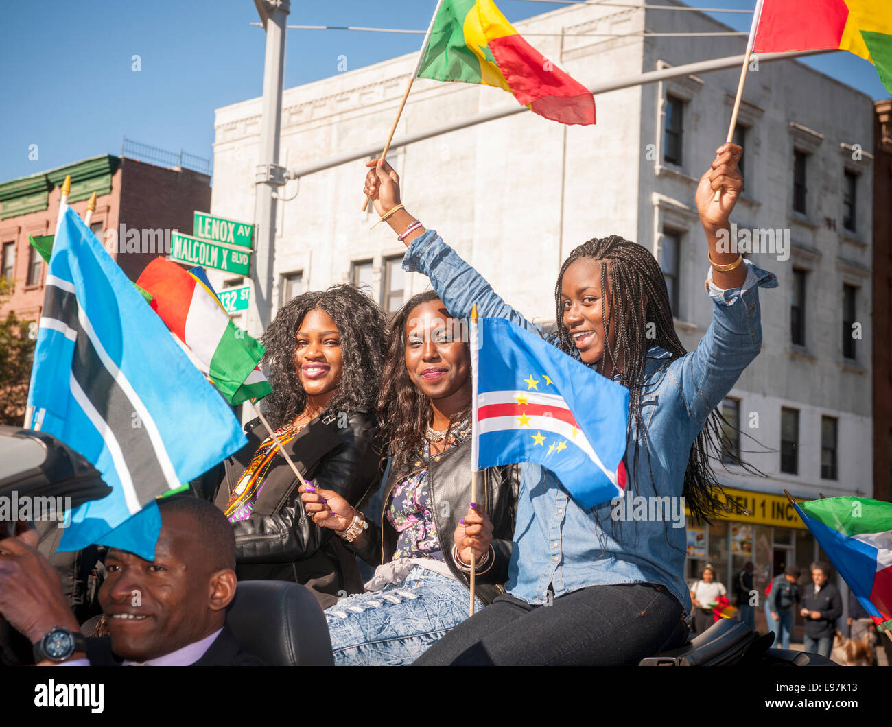 Participants carry flags from many African nations marching in the
