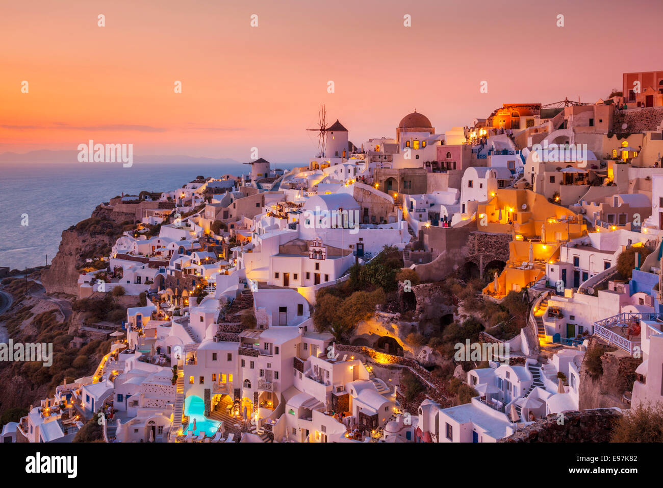 Windmill & white houses at sunset  in the village of Oia, Santorini, Thira, Cyclades Islands, Greek Islands, Greece, EU, Europe Stock Photo