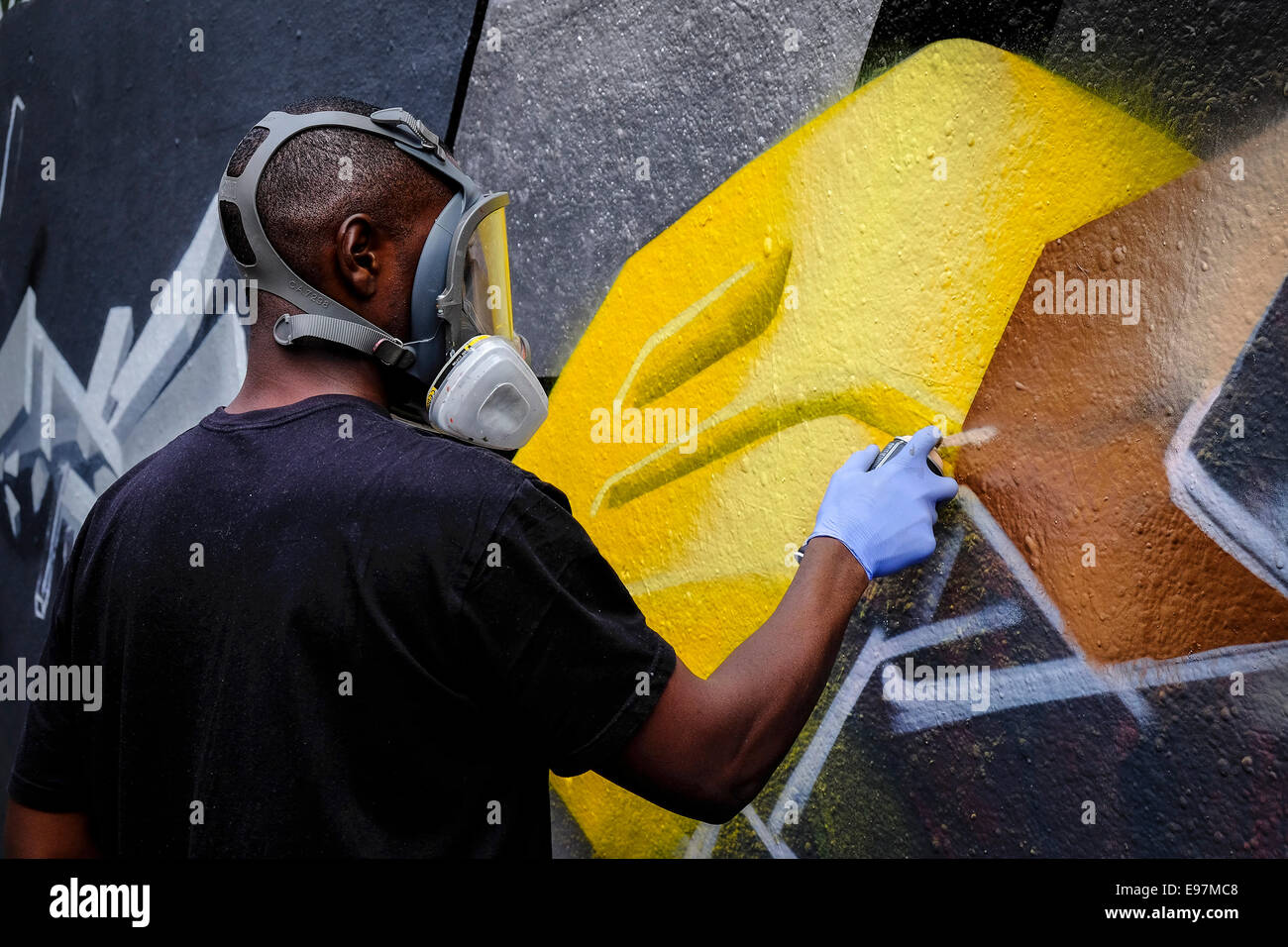 A graffiti artist decorating a wall in Leake Street in Waterloo. Stock Photo