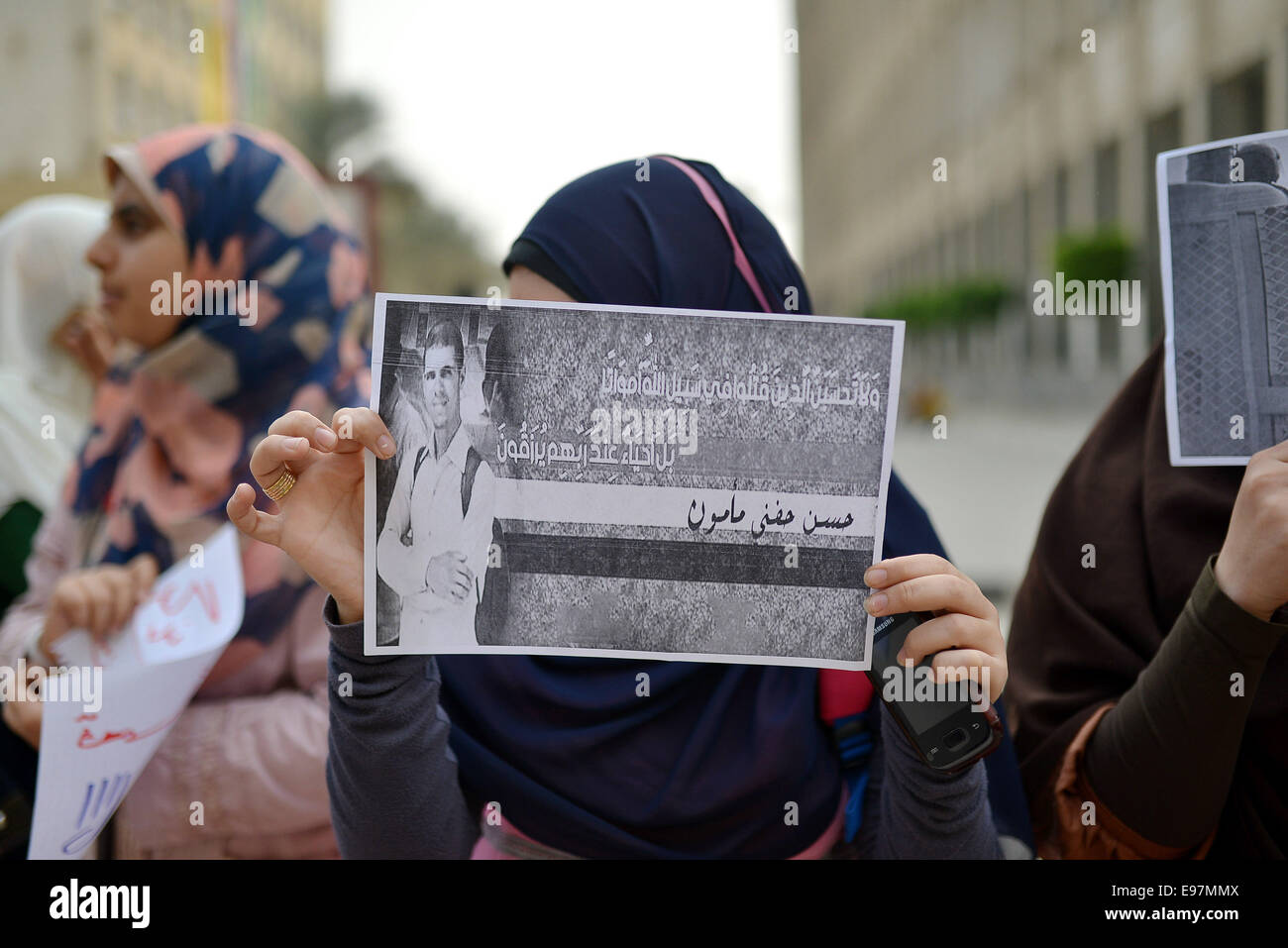 Cairo, Egypt. 21st Oct, 2014. Egyptian students who support Muslim Brotherhood and ousted president Mohammed Morsi, hold placards during a demonstration against military rule and to demand for release their fellows, at Cairo University, in Cairo, October 21, 2014. Anti-Coup students have launched a week-long 'breaking the siege' campaign in protest against security forces tight grip on university campuses across Egypt Credit:  Amr Sayed/APA Images/ZUMA Wire/Alamy Live News Stock Photo