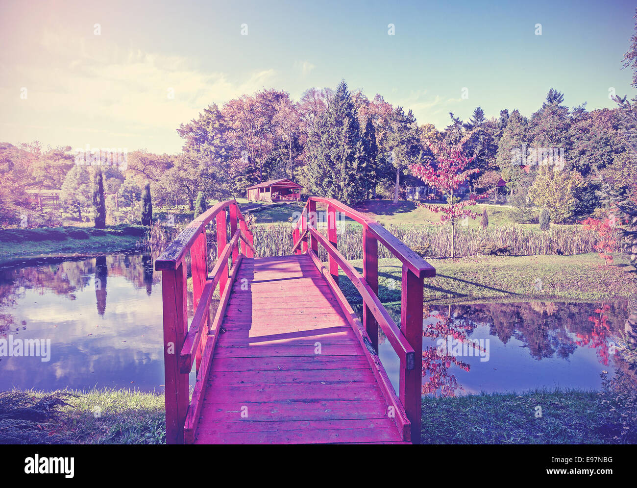 Vintage picture of red bridge in garden. Stock Photo