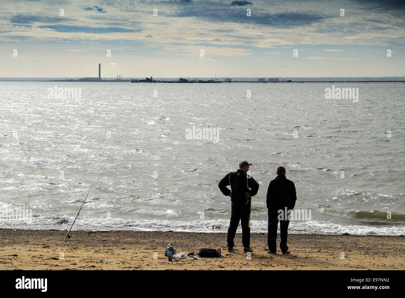 Two men fishing on Jubilee Beach in Southend in Essex Stock Photo Alamy