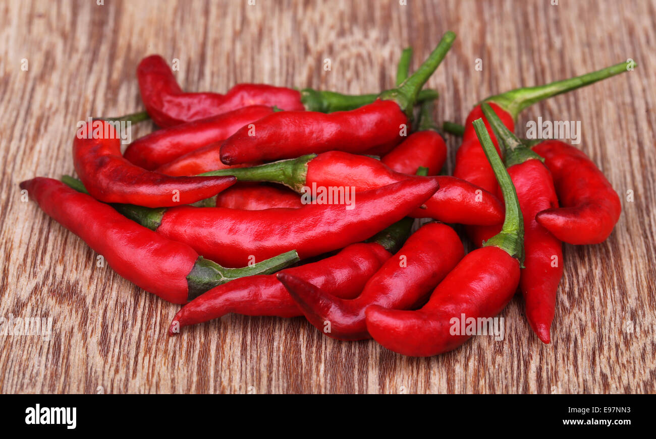 Red chilies on wooden surface Stock Photo