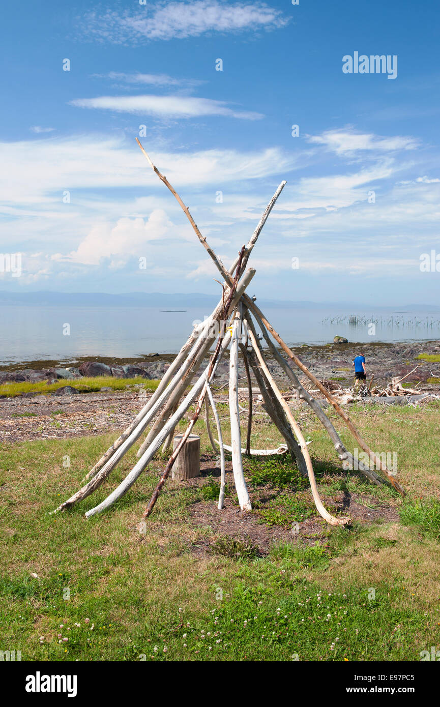 Driftwood tepee structure on the shores of St Lawrence river near Kamouraska, province of Quebec, Canada. Stock Photo