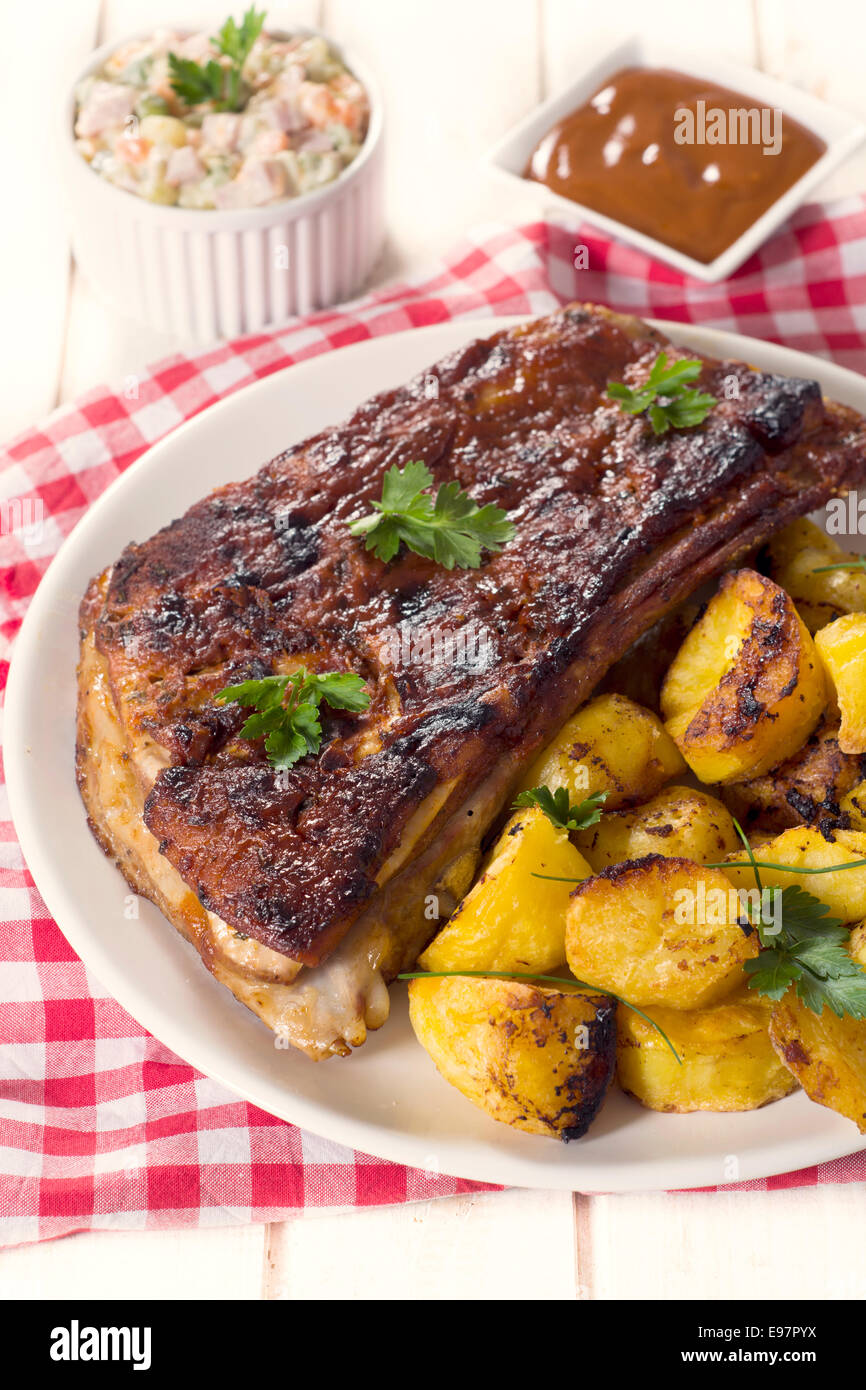 Baked potato and bbq beef ribs in the plate,selective focus Stock Photo