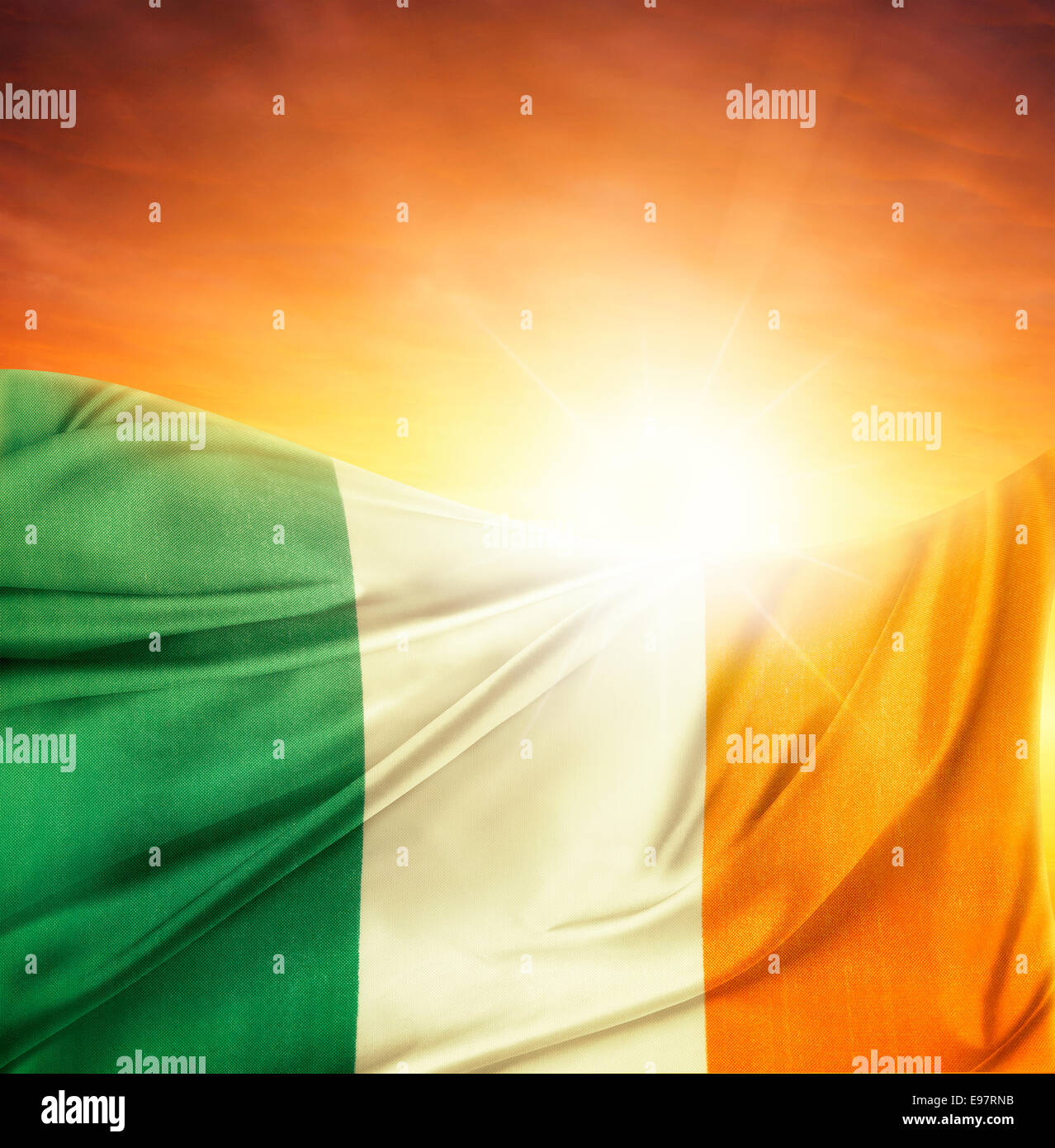 Irish flag in front of bright sky Stock Photo