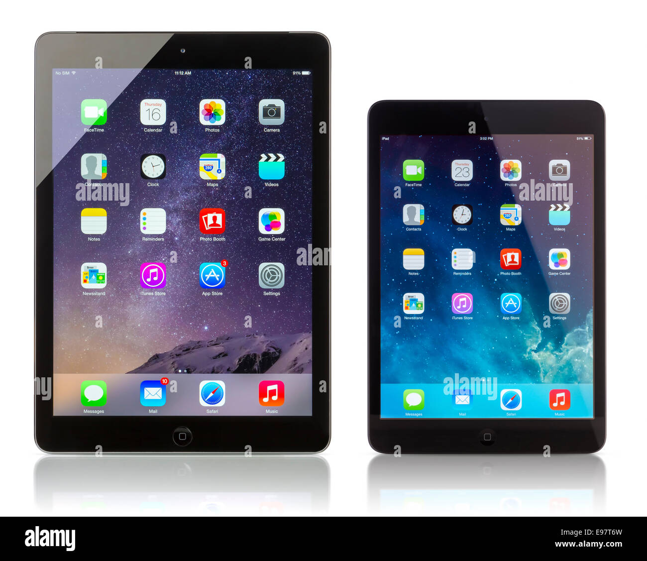 Apple iPad Air Wi‑Fi + Cellular displaying iOS 8 and iPad Mini with iOS 7.1 homescreen. iOS Stock Photo