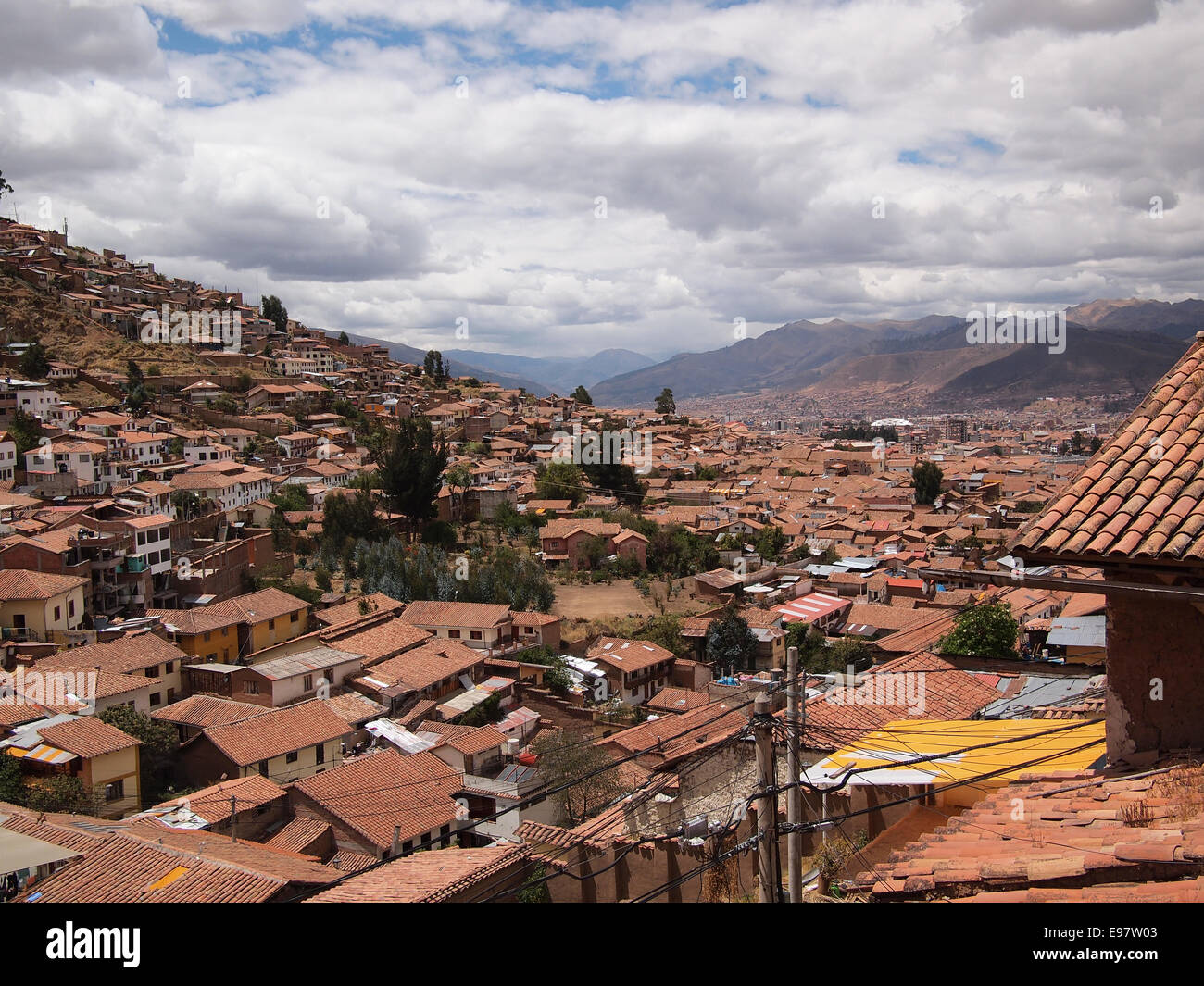 View over the orange tile roofs of the touristic city center of Cusco, near Machu Picchu, in Peru. Stock Photo